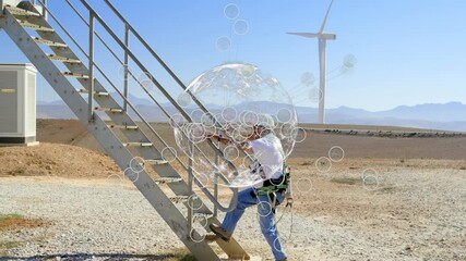 Animation of globe and network of connections over caucasian man and wind turbines - Powered by Adobe