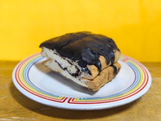 A slice of warm bread with chocolate sprinkles on top adds to its deliciousness. Perfect for culinary, product, hospitality, or advertising. Close-up. Copy space. Selective focus.