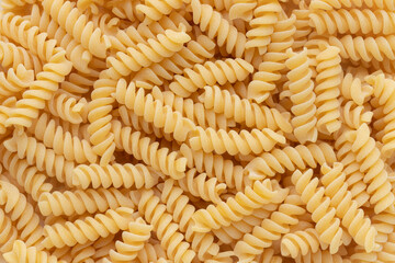 Top view of raw fusilli pasta for a background