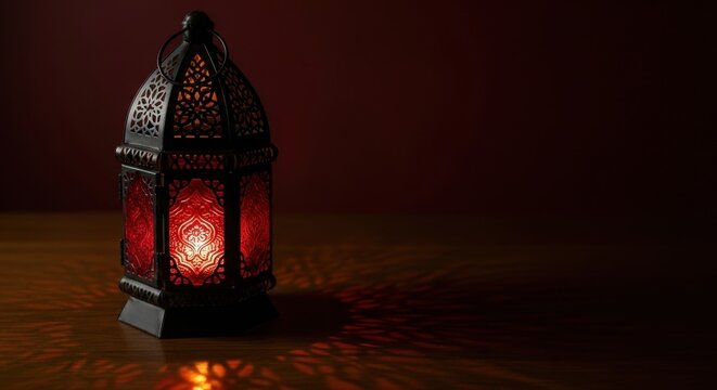 Intricate moroccan lantern casts warm glow on wooden table in dimly lit room