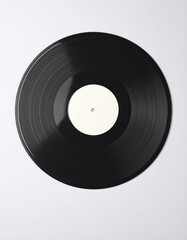 Obraz premium Black vinyl record against white. The record has a blank label. Grooves are visible. The image is shot from directly above