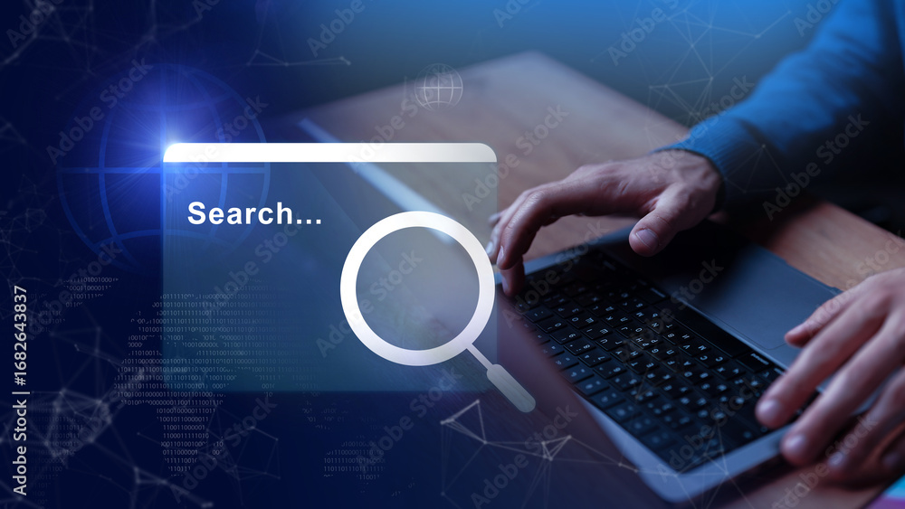 Poster searching for information using a laptop in a modern workspace during the daytime