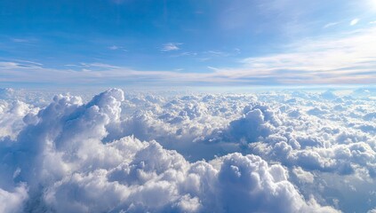 High-angle view of a vast expanse of puffy white clouds against a vibrant blue sky