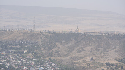 Smog pollution covering cityscape of Tbilisi, the capital of Georgia, aerial panoramic view from Mtatsminda Park