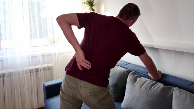 Man with hip, back and sciatica pain at home.