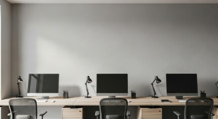 Interior view of a modern office workspace featuring computer monitors, desks, and chairs.