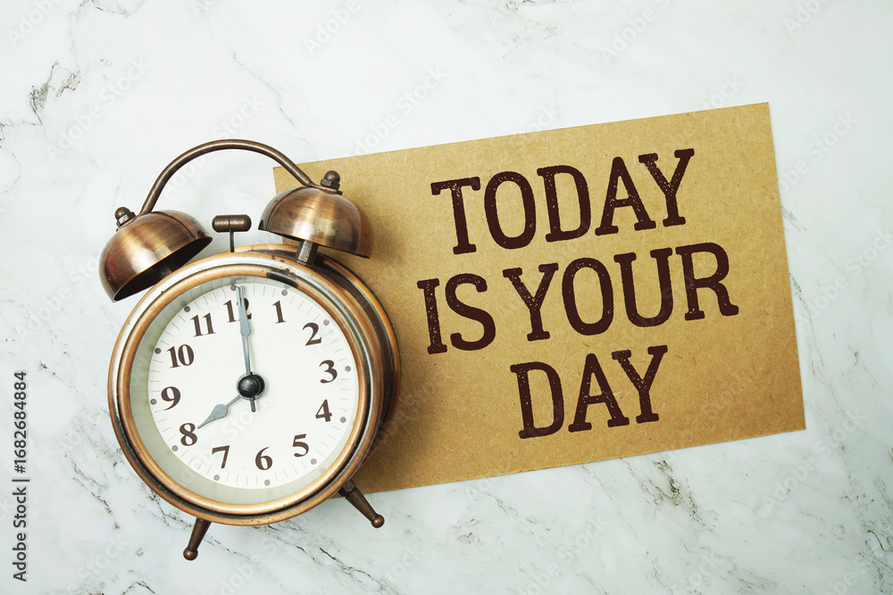 Poster today is your day text written on paper card with alarm clock on marble background