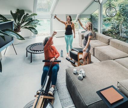 Family working out and celebrating together at home in living room