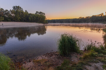 Early morning scene with fog over river