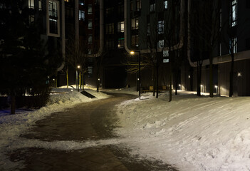 Blurred background of a tranquil winter evening scene featuring a quiet, snow-covered path...