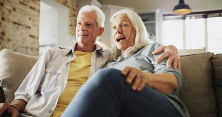 Obraz premium Senior couple, hug and watching tv with surprise on sofa for horror movie, bonding or scary series. Happy, elderly people and relax in house with thriller show, weekend break and retirement support