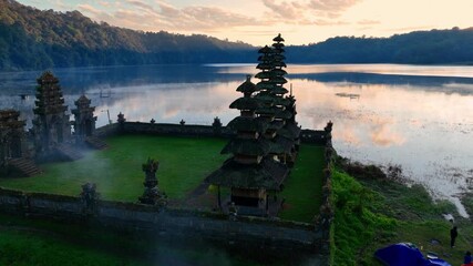 sacred Balinese traditional water temple at sunrise, travel in Bali, south asian culture, drone shot of hindu temple complex in Bali, Indonesia