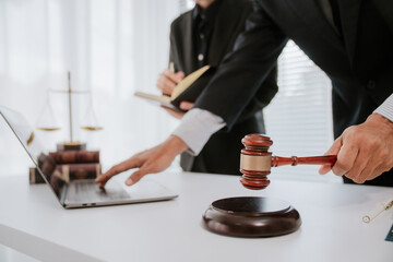 concept of justice and law A male judge in the courtroom on a wooden table and a male counselor or...