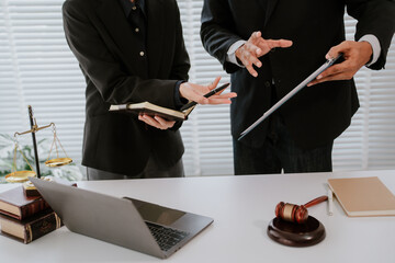 concept of justice and law A male judge in the courtroom on a wooden table and a male counselor or...