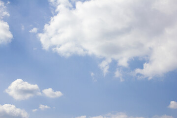 The sky is covered with fluffy clouds.
