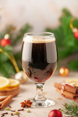 German christmas drink glühbier. Hot beer with spices -  cinnamon, anise stars, citrus and gloves. Mulled dark beer.