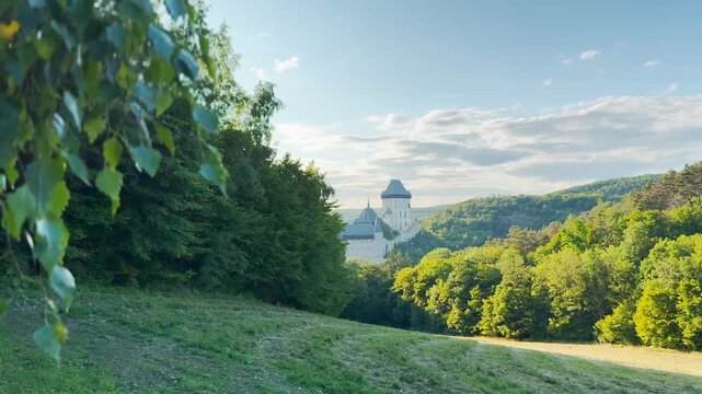 Karl&scaron;tejn Castle revealed through green foliage