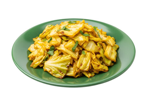 Savory, golden-brown saut?ed cabbage, garnished with fresh herbs, sits attractively on a vibrant green plate against a stark black backdrop.