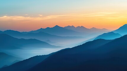 Fototapeta premium A serene mountain landscape at sunset with layers of mist and a vibrant orange sky.