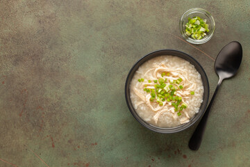 Dakjuk. Korean rice chicken porridge with spring onions. Top view