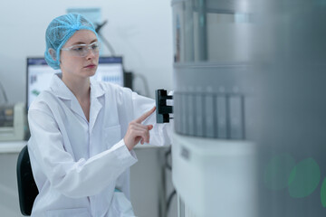 A medical technologist loads a sample rack into an automated immunoassay analyzer, initiating the...