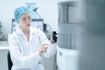 A medical technologist loads a sample rack into an automated immunoassay analyzer, initiating the...