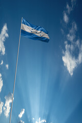 Waving National flag of Honduras on flagpole in sky