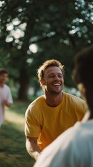 Naklejka premium Young people enjoying a sunny afternoon playing together in a park while smiling and laughing near trees
