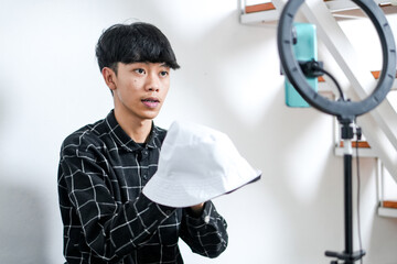Young Asian Man As Content Creator Reviewing Product On His Live Stream Or Content