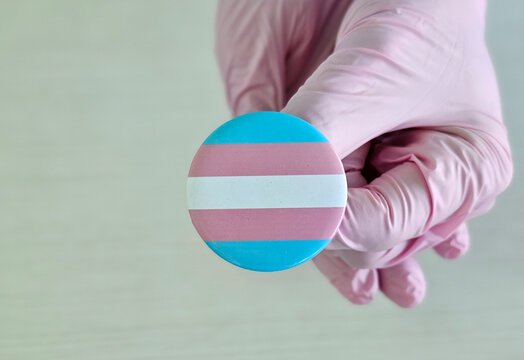 Pink and blue button featuring the transgender pride flag