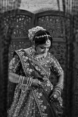 Black and white portrait of an Indian bride in traditional attire, symbolizing timeless love, elegance, and cultural heritage with strong artistic and emotional concept.