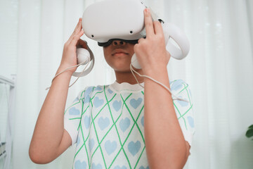 Elementary student learning with VR headset in classroom. Immersive edtech.