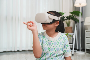 Child wearing VR headset gesturing in virtual world.
