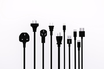 Electrical Connectors Array: A graphic composition of black power plugs and USB connectors, each poised in a clean line, offering a glimpse into global connectivity and device integration.