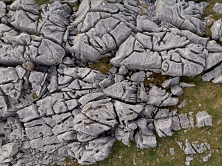 Intricate limestone pavement textures are seen in an aerial shot of a natural landscape.