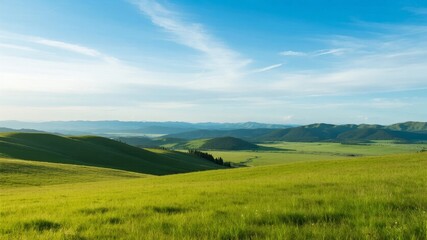 Obraz premium Vast Green Landscape with Rolling Hills Under a Clear Blue Sky