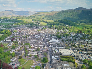 An aerial view captures the charming town of Keswick nestled amongst the hills of Cumbria, England. © Li