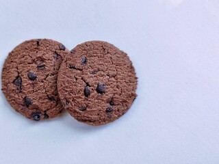 Closeup of delicious chocolate chip cookies arranged on white background, sweet baked snack dessert for food photography and culinary design.