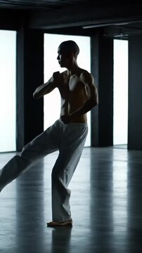 lean, athletic, gender-neutral figure performs precise martial arts katas in a minimalist modern studio with dark walls, dramatically lit with chiaroscuro and backlighting, conveying intense focus