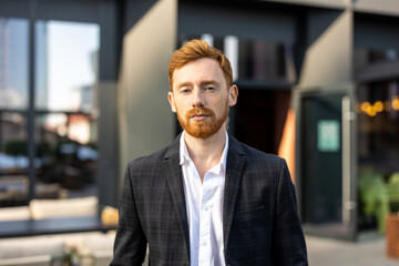Young businessman wearing official style suit standing outdoor near office building