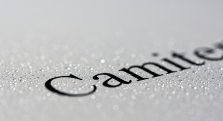 Black text on white surface with water droplets word