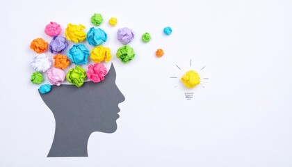 Abstract head silhouette with colorful crumpled paper representing thoughts/ideas. A yellow paper lightbulb conveys inspiration on a white background