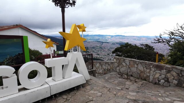 Large Bogot&aacute; sign at Monserrate viewpoint with scenic city views in the background, showcasing a popular tourist attraction in Bogot&aacute;, Colombia
