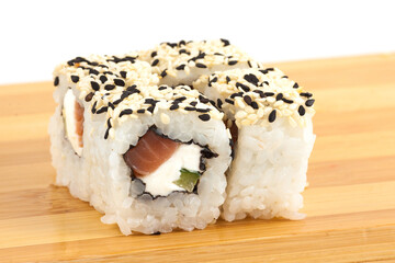 Delicious Sushi Roll with Sesame Seeds on Wooden Surface