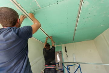 Two man help for ceiling house construction