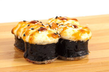 Deliciously Baked Sushi Rolls Topped with a Spicy Flavor Kick