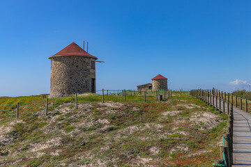 Ancient windmills at Apulia beach