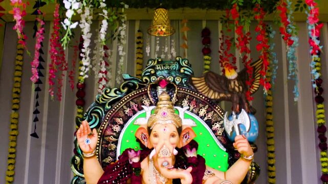 Beautiful Ganpati idol in decorated pandal for Ganesh Chaturthi celebration. Perfect for festival, culture and devotional stock footage needs.