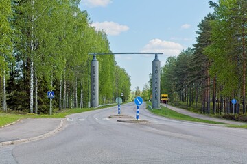 Welcome (Tervetuloa) to Savitaipale sign on wooden poles in spring weather with clouds,...