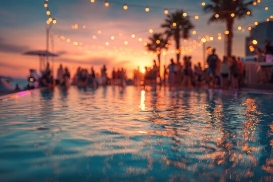 Blurred party people at a beach pool during sunset person water reflection.